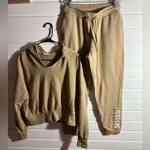 Tan sweat set with white detailing on legs of pants.